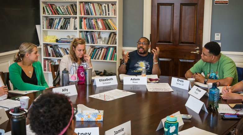 Educators hold a discussion around the Harkness table during the 2018 Exeter Harkness Institute.